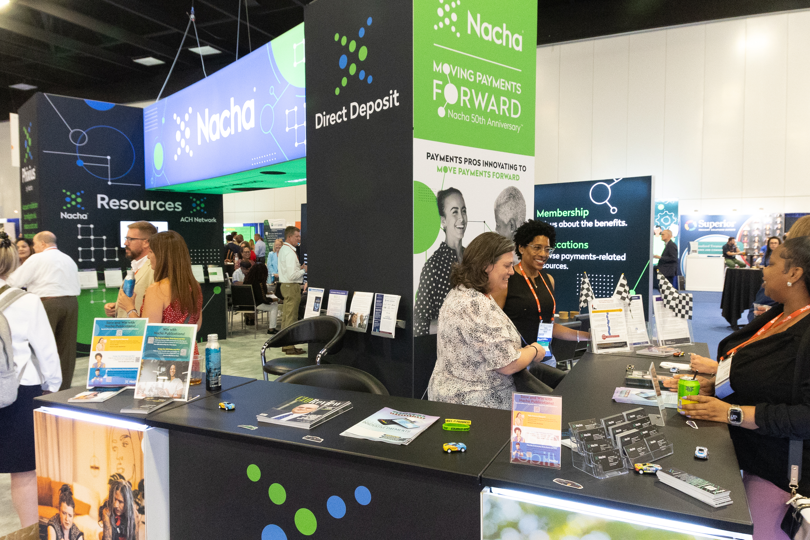 People at a conference visiting a booth