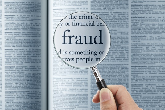 the word fraud under a magnifying glass