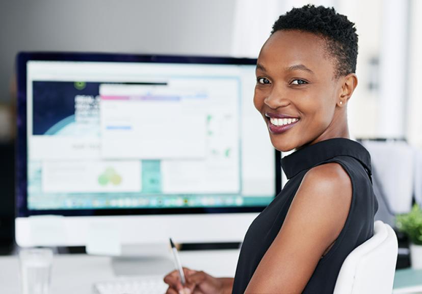 Female smiling at computer
