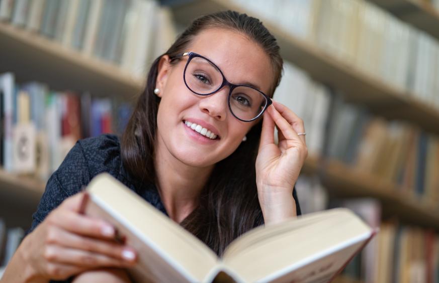 Payments Institute happy woman reading glasses