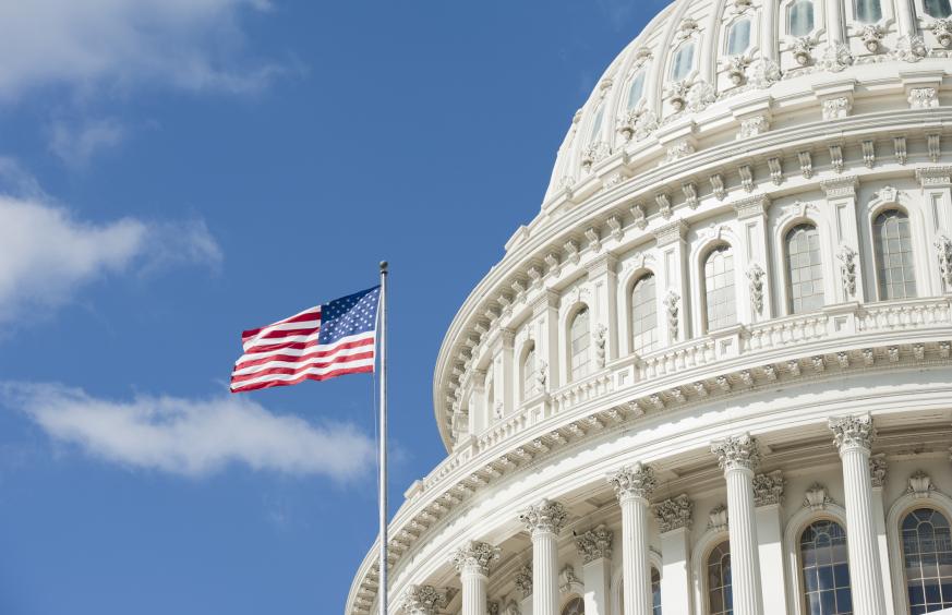 American flag waving in front of Capitol Hill Building in Washington DC