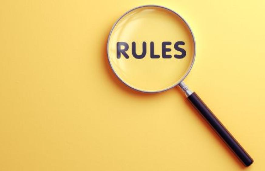 The word Rules under a magnifying glass