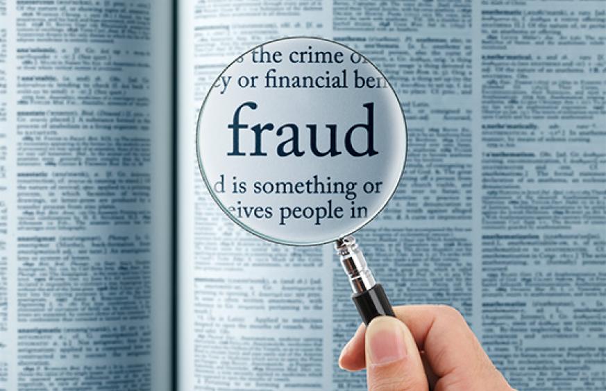 the word fraud under a magnifying glass