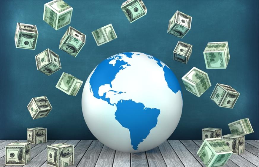 a globe surrounded by blocks made of u.s. dollars