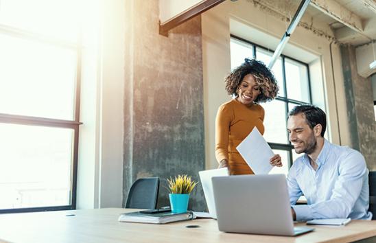 Man woman at computer smiling