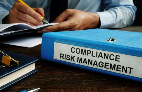 looseleaf with "compliance risk management" on it