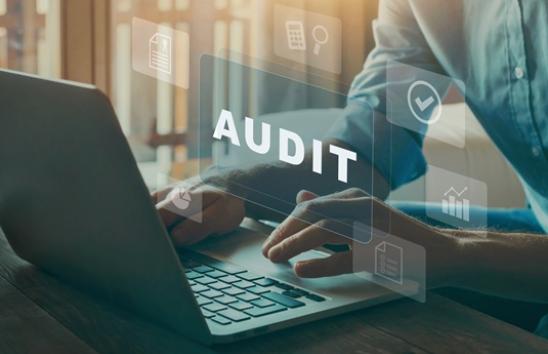 the word audit with a laptop