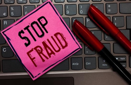 The words stop fraud on a keyboard
